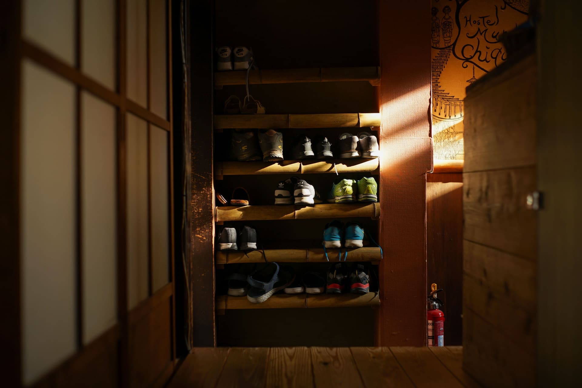 Shoes and boots stored on a rack in a home entryway